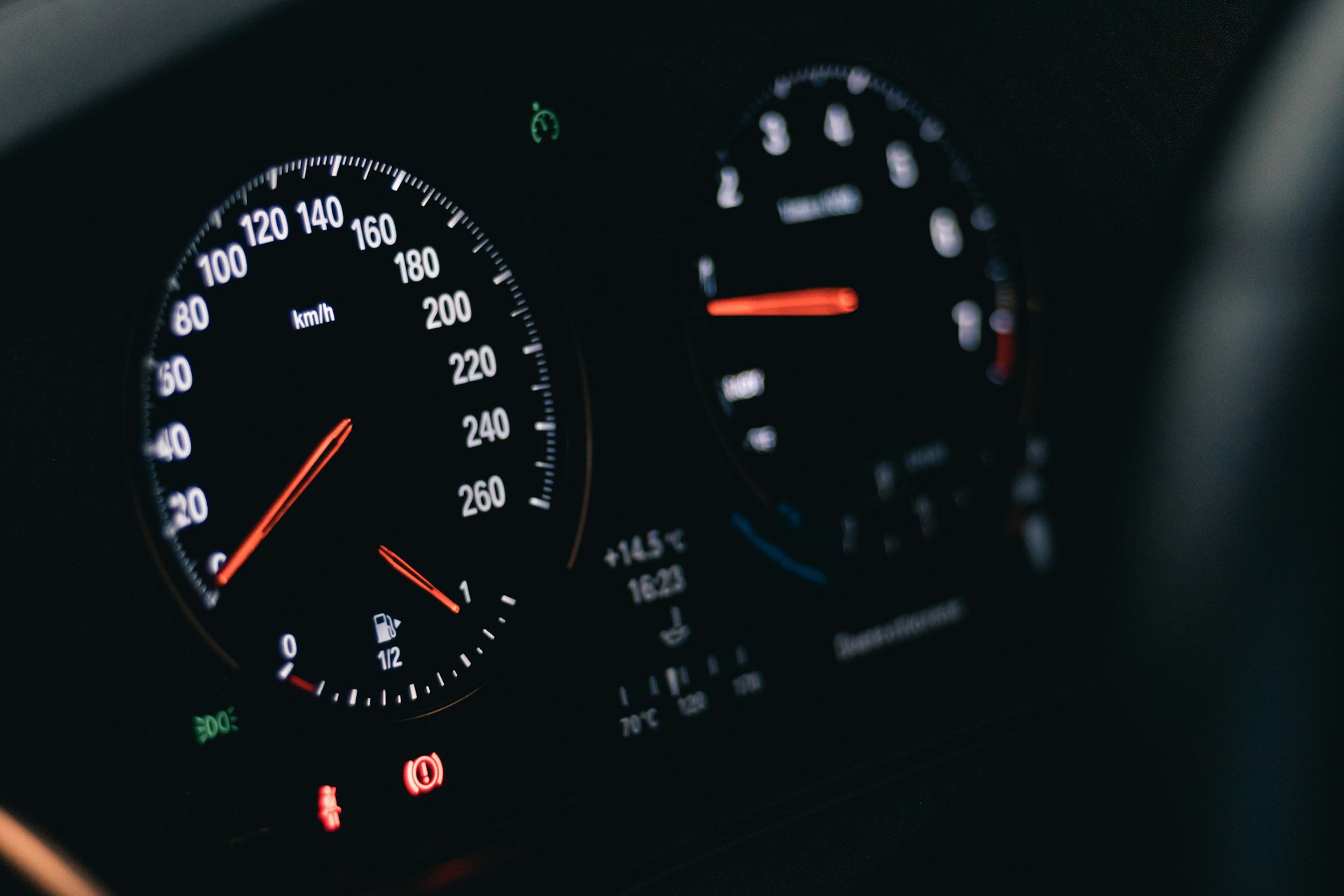 black and white analog instrument panel cluster